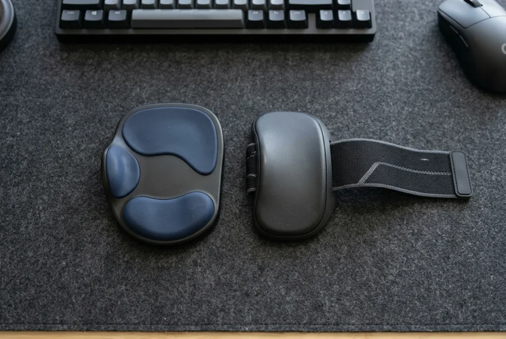 Black Carpio 2.0 BadSeed Tech Edition wrist rest next to a strapped Carpio G2.0 on a felt desk mat